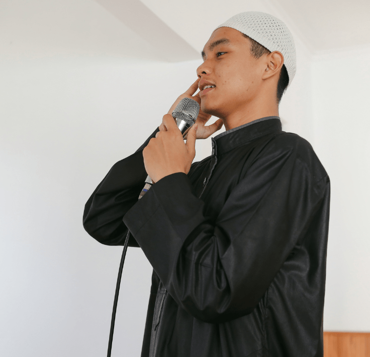 Imam performing the Adhan, the call to prayer for Salat